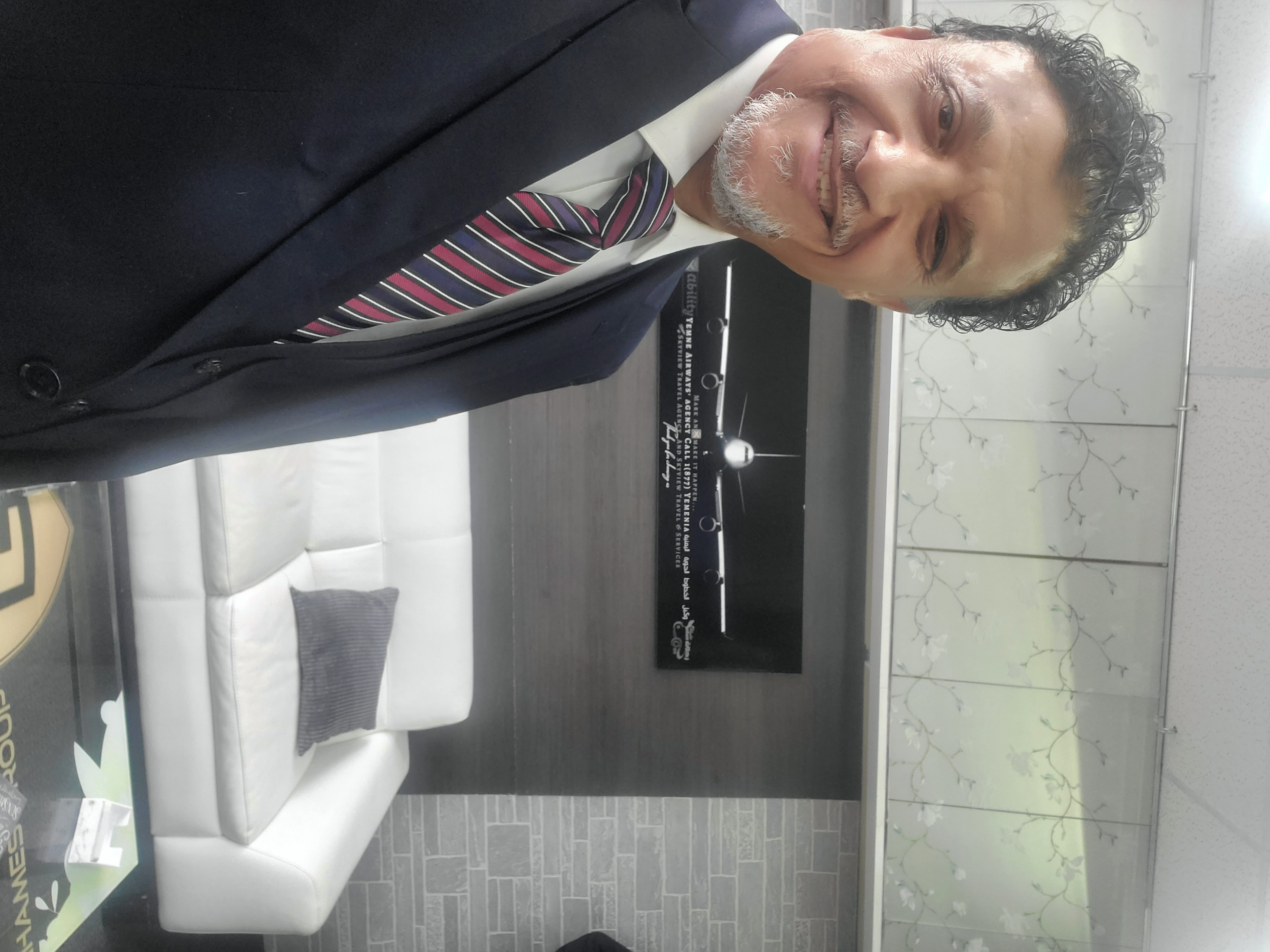 Mohammad Ghames welcoming clients at the FlyXability service desk, Hamtramck